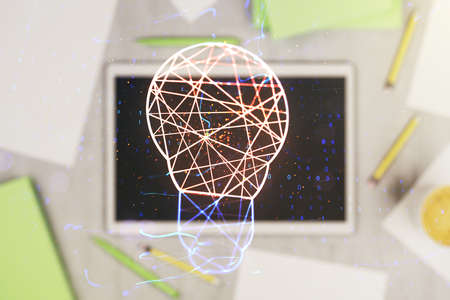 Creative light bulb hologram and modern digital tablet on background, idea concept. Multiexposureの写真素材