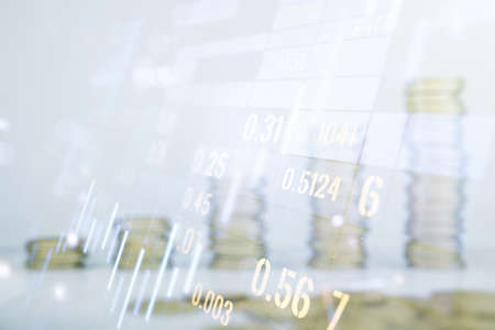 Abstract virtual financial graph hologram on coins background, financial and trading concept. Multiexposureの写真素材