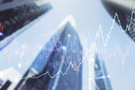 Double exposure of abstract financial diagram on office buildings background, banking and accounting conceptの写真素材