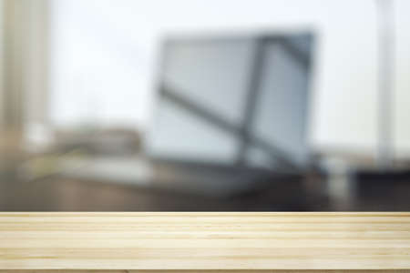 Empty office wooden table with empty space on modern workplace with computer background, close up, mockupの写真素材
