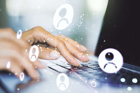 Double exposure of social network icons concept with hand typing on computer keyboard on background. Networking conceptの写真素材