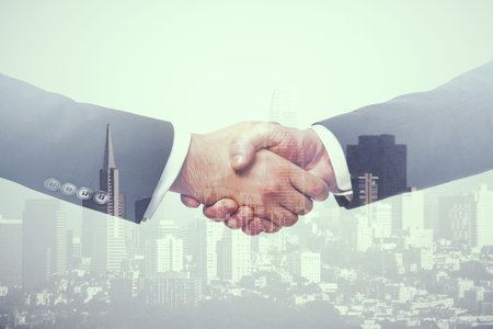 Multi exposure of handshake two businessmen on city skyline background, cooperation and coworking...