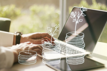 Double exposure of cash savings hologram and hands typing on laptop on background. Development and...