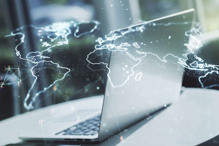 Double exposure of abstract digital world map on laptop background, research and strategy conceptの写真素材