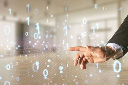 Man hand clicks on abstract virtual binary code hologram on blurred office background, AI and machine learning concept. Multiexposureの写真素材