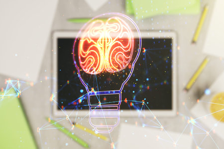 Creative light bulb illustration with human brain and modern digital tablet on desktop on...
