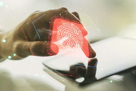 Multi exposure of creative fingerprint hologram with finger presses on a digital tablet on background, personal biometric data conceptの写真素材