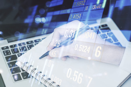 Multi exposure of abstract creative financial graph with hand writing in notepad on background,...