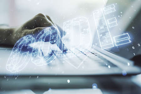 Creative Code word sign and hands typing on laptop on background, international software development concept. Multiexposureの写真素材