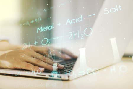 Creative chemistry hologram with hands typing on computer keyboard on background, pharmaceutical...