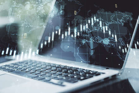 Double exposure of abstract creative financial chart with world map on laptop background, research and strategy conceptの写真素材