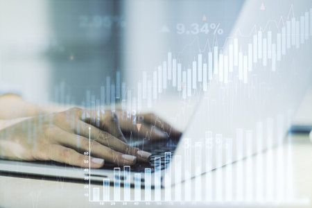 Multi exposure of abstract creative financial graph with hand typing on laptop on background, forex...