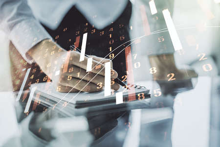 Double exposure of abstract creative financial chart with hand writing in notebook on background, research and strategy conceptの写真素材