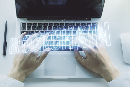 Creative abstract blockchain technology sketch and hands typing on computer keyboard on background,...