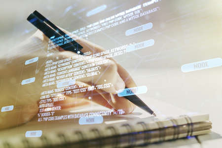 Double exposure of abstract creative programming illustration and man hand writing in notepad on background, big data and blockchain conceptの写真素材