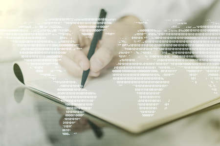 Double exposure of abstract digital world map and man hand writing in notebook on background, research and strategy conceptの写真素材