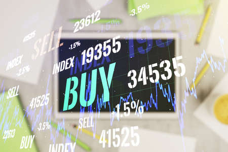 Abstract creative financial graph and modern digital tablet on desktop on background, top view, financial and trading concept. Multiexposureの写真素材