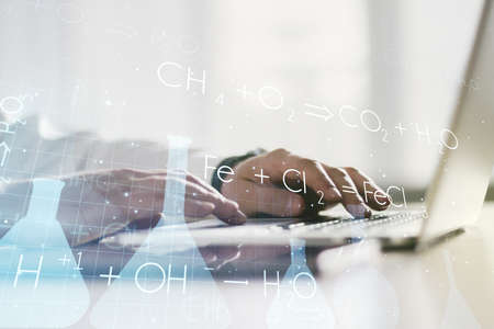 Creative chemistry illustration with hands typing on computer keyboard on background, science and research concept. Multiexposureの写真素材