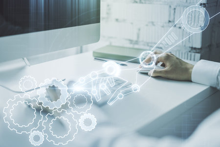 Creative abstract robotics technology hologram and hands typing on computer keyboard on background,...