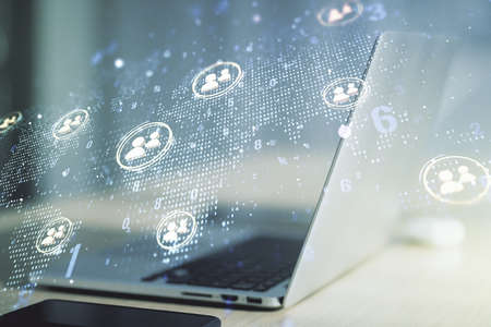 Double exposure of social network icons concept with world map and modern laptop on background. Marketing and promotion conceptの写真素材