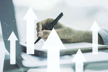 Creative abstract upward arrows sketch and hand writing in notepad on background with laptop, target and goal concept. Multiexposureの写真素材