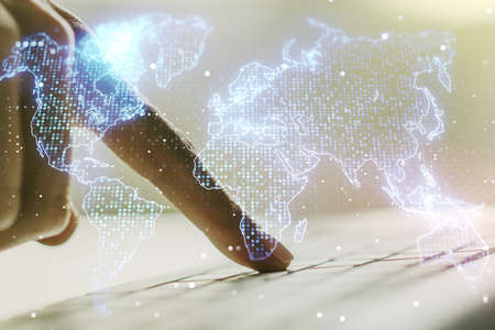 Double exposure of abstract digital world map and hand typing on laptop on background, big data and blockchain conceptの写真素材