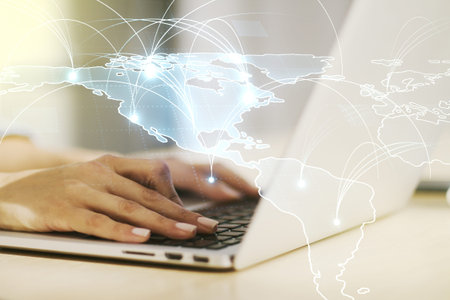 Double exposure of abstract digital world map with connections and hand typing on computer keyboard...