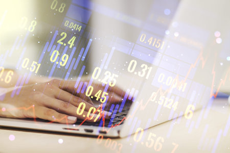 Double exposure of abstract creative financial diagram with hand typing on computer keyboard on...