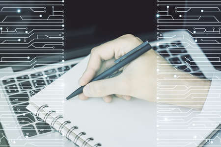 Creative abstract micro chip hologram and hand writing in diary on background with laptop, artificial intelligence and machine learning concept. Multi exposureの写真素材