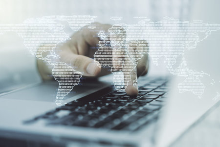 Double exposure of abstract digital world map and hand typing on laptop on background, big data and...