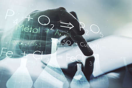Creative chemistry concept with finger clicks on a digital tablet on background. Multiexposureの写真素材