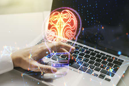 Creative light bulb with human brain hologram and with hands typing on computer keyboard on background, artificial Intelligence and neural networks concept. Multiexposureの写真素材
