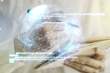 Abstract creative coding concept with world map and man hand writing in notebook on background. Multiexposureの写真素材