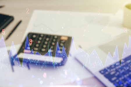 Double exposure of abstract virtual statistics data hologram on blurry calculator with laptop...
