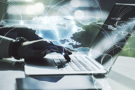 Double exposure of abstract digital world map with connections and hand typing on computer keyboard...