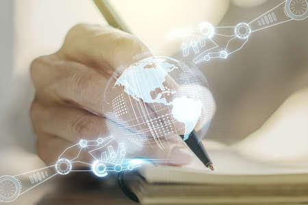 Creative concept of robotics technology with globe sketch and woman hand writing in notebook on background. Robot development and automation concept. Multiexposureの写真素材