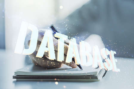 Double exposure of creative Database word hologram and man hand writing in diary on background, research and development conceptの写真素材