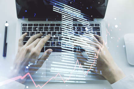 Double exposure of creative Bitcoin symbol with hands typing on laptop on background. Cryptocurrency conceptの写真素材