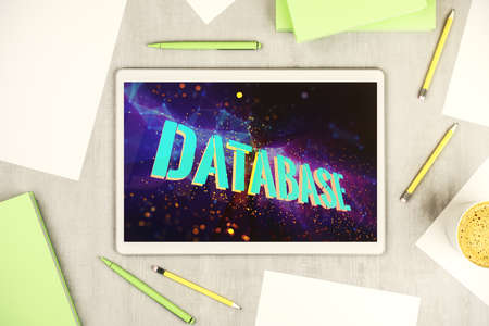 Top view of modern digital tablet monitor with Database word sign, global research and analytics concept. 3D Renderingの写真素材