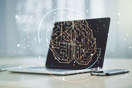 Creative artificial Intelligence concept with human brain hologram on modern laptop background. Multiexposureの写真素材