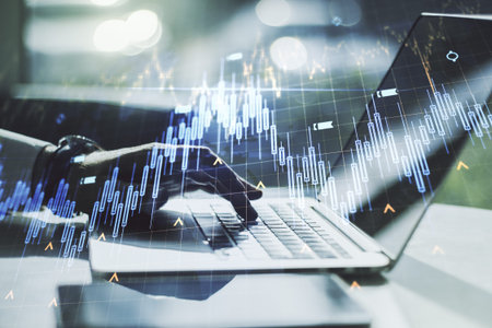 Multi exposure of abstract financial diagram with world map and with hand typing on computer...