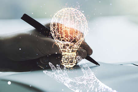 Creative light bulb illustration with hand writing in notepad on background, future technology concept. Multiexposureの写真素材