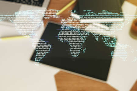 Abstract creative world map and modern digital tablet on background, top view, international trading concept. Multiexposureの写真素材