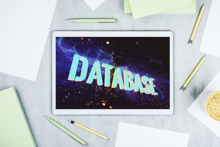 Modern digital tablet monitor with creative Database word hologram, research and development...