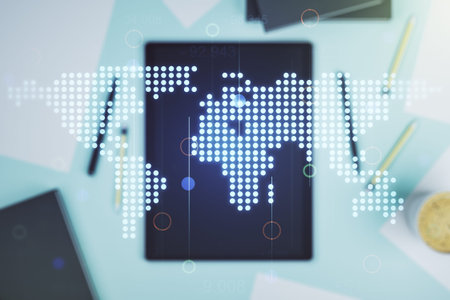 Abstract creative digital world map and modern digital tablet on desktop on background, top view,...