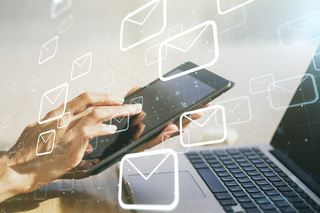 Creative concept of postal envelopes illustration with finger clicks on a digital tablet on background. Email and communications concept. Multiexposureの写真素材