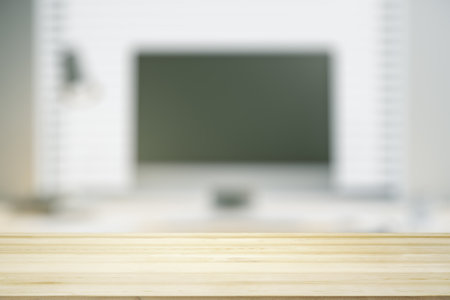 Empty wooden office table with light sunny workplace with computer on background, mock upの写真素材