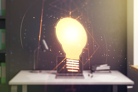 Double exposure of creative light bulb hologram and modern desktop with laptop on background, research and development conceptの写真素材