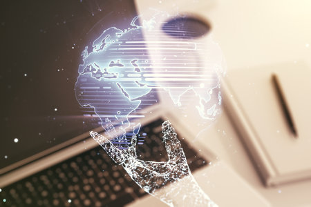 Abstract creative world map on modern laptop background, international trading concept. Multiexposureの写真素材