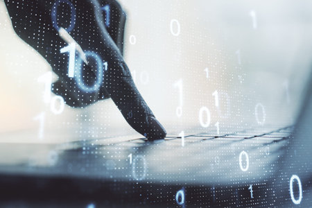 Double exposure of creative abstract binary code hologram and hands typing on laptop on background....